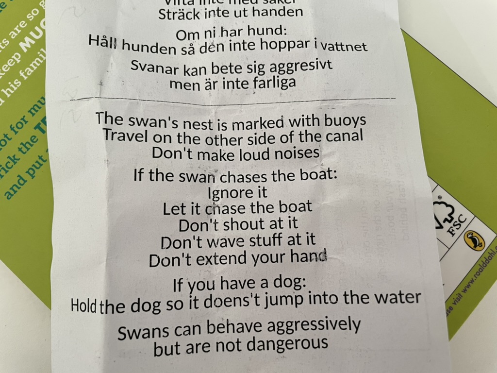 The swan's nest is marked with buoys.
Travel on the other side of the canal.
Don't make loud noises.
If the swar chases the boat:
Ignore it.
Let it chase the boat.
Don't shout at it.
Don't wave stuff at it.
Don't extend your hand.
If you have a dog:
Hold the dog so it doens't jump into the water.
Swans can behave aggressively but are not dangerous.