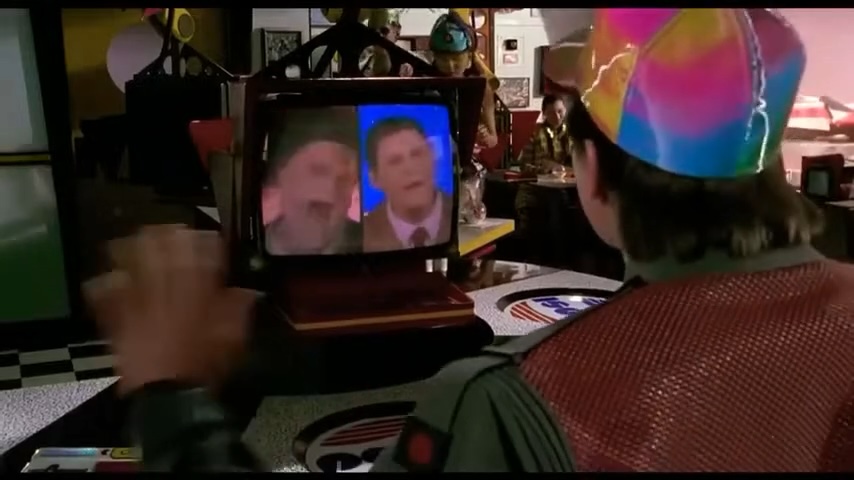 Back to the Future 2 scene in Cafe 80s where Marty tries to order a Pepsi from a video screen and two AI waiters begin to argue on it