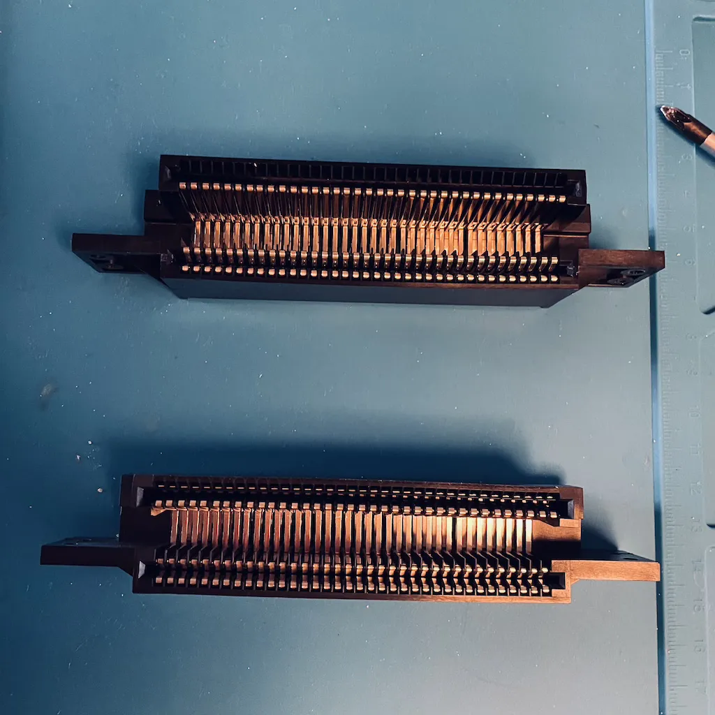 2 72 pin connectors for the original 8-bit Nintendo side-by-side on a blue mat
