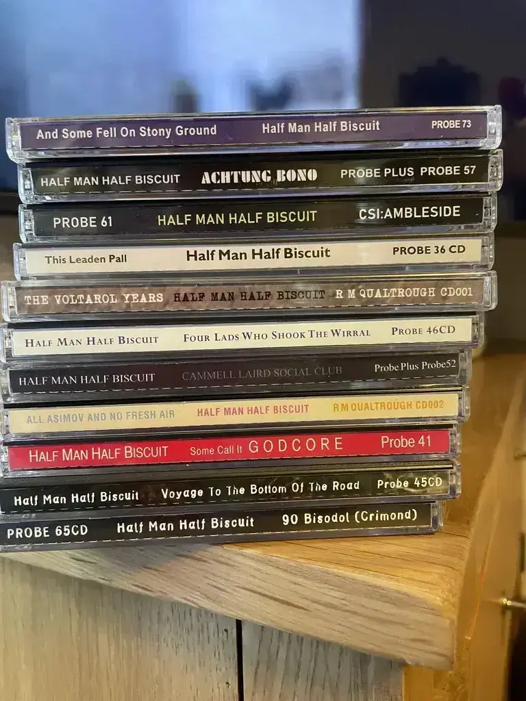 A stack of Half Man Half Biscuit albums in CD format.