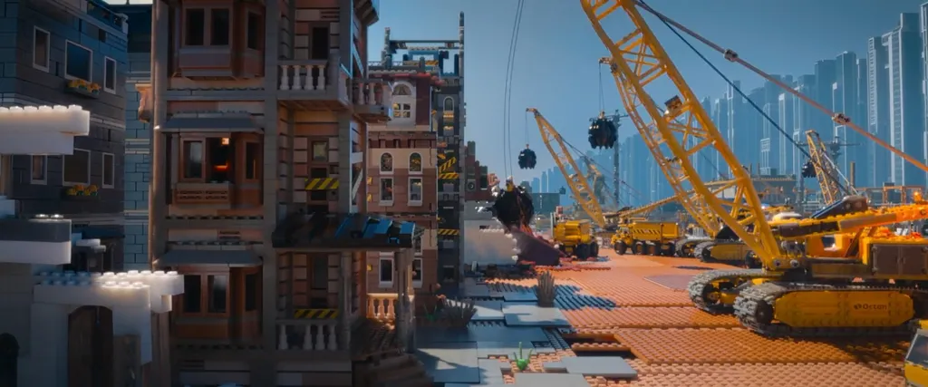 Movie still with three storey tall Lego townhouses on the left and large skyscrapers on the right, with wrecking balls in the centre about to destroy the old townhouses